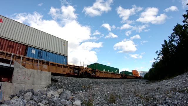 Antique train long freight with container loading running on railway passing  in valley at Calgary