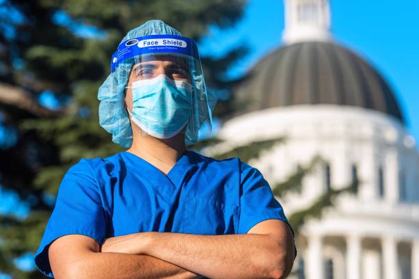 healthcare worker standing in front of a capitol building - department of health and human services imagens e fotografias de stock