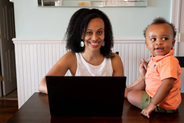 istock Black woman working from home with her baby son 1266827671
