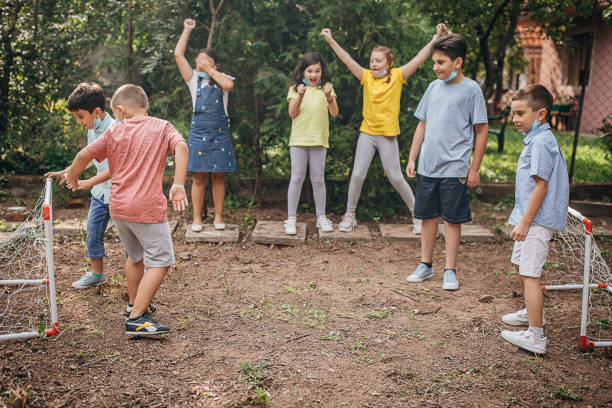 istock Group of kids playing soccer in backyard 1266828419