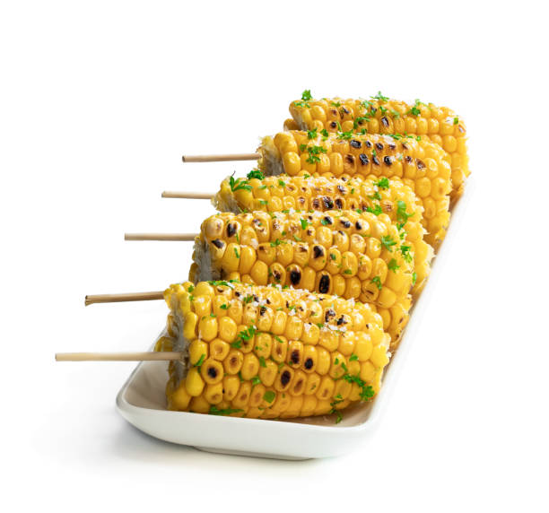 Grilled sweet corn on the cob isolated on white