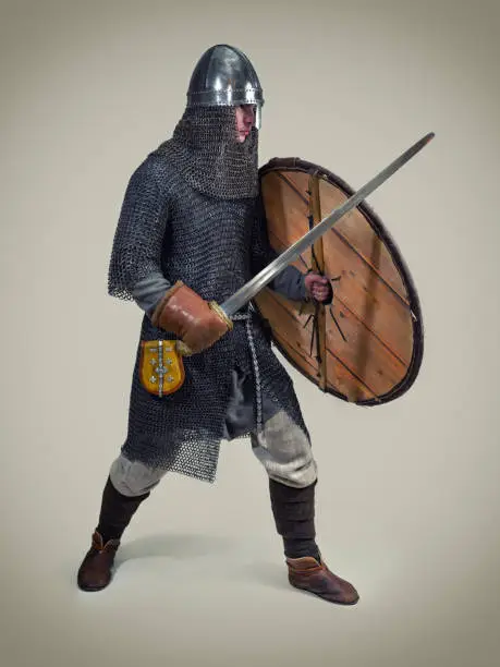Young man in clothes and armour from the early middle ages.