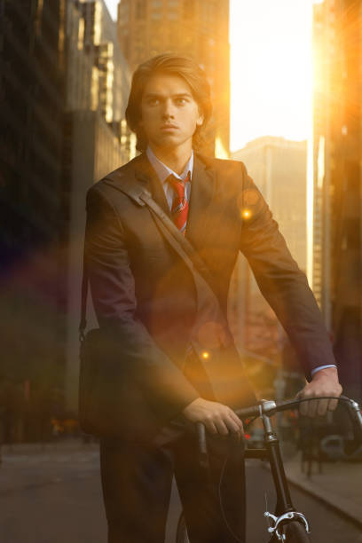 istock Handsome brunette business man commuting to work by bicycle wearing suit and tie 1266833748