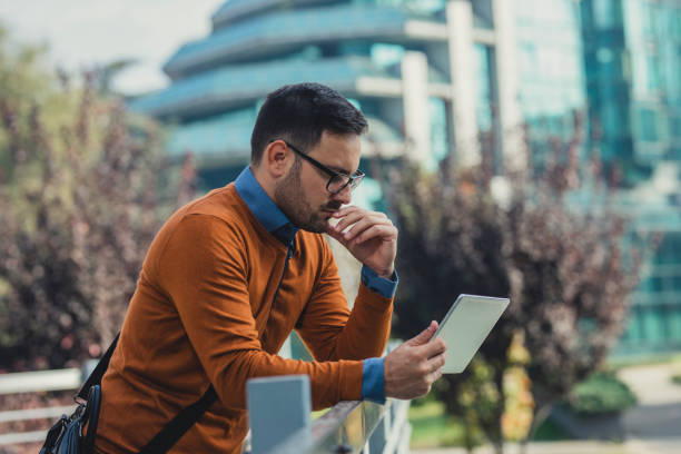 istock Businessman Using a Digital Tablet PC on the Street 1266833885