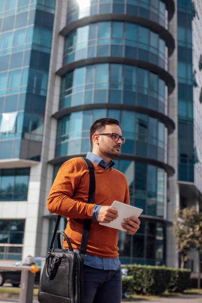 istock Young Businessman Using a Digital Tablet on the Street 1266833899