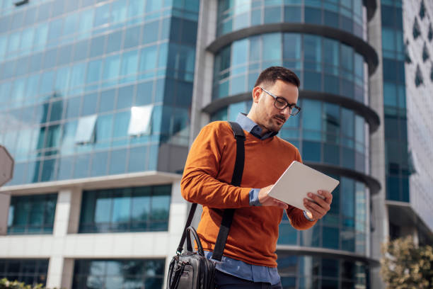 istock Young Businessman Using a Digital Tablet on the Street 1266833901