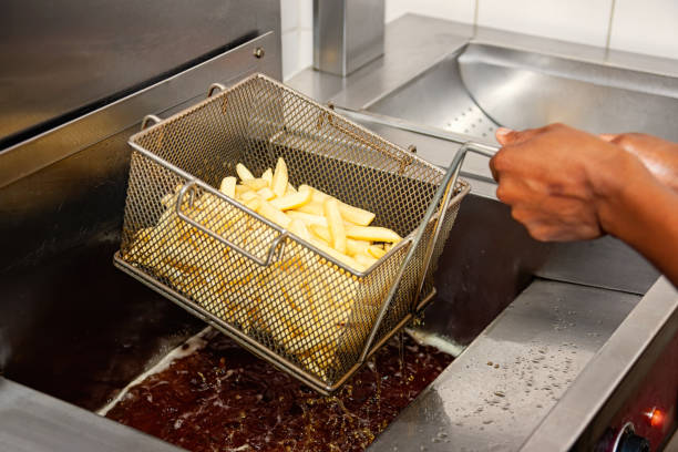 istock fast food, potato chips being cooked in a basket 1266833953