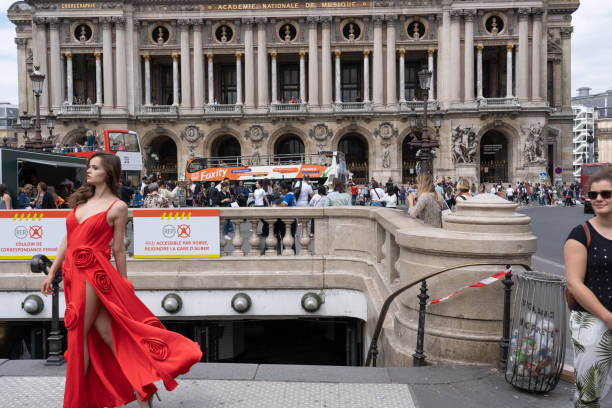 Academy national of music with photo shooting of red dress in foreground. Focus on background. Paris - France, 31. may 2019 stock photo