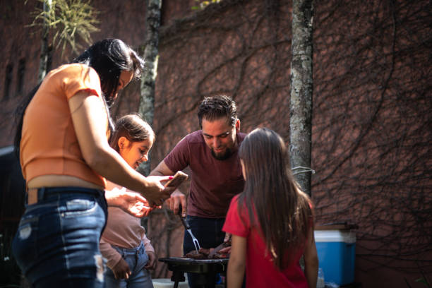 istock Family doing a barbecue together in the backyard 1266834052