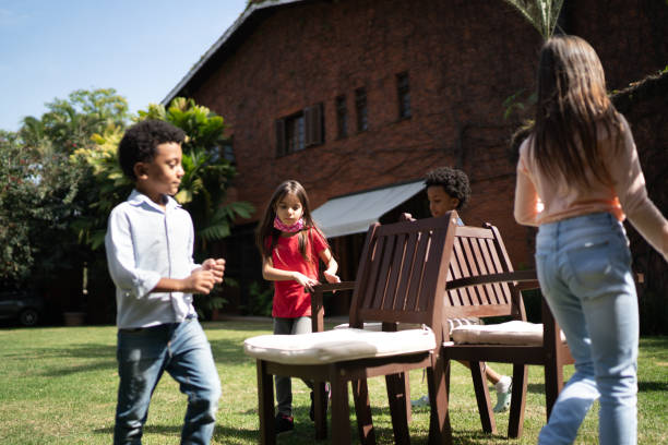 Kids playing dancing chairs in the backyard