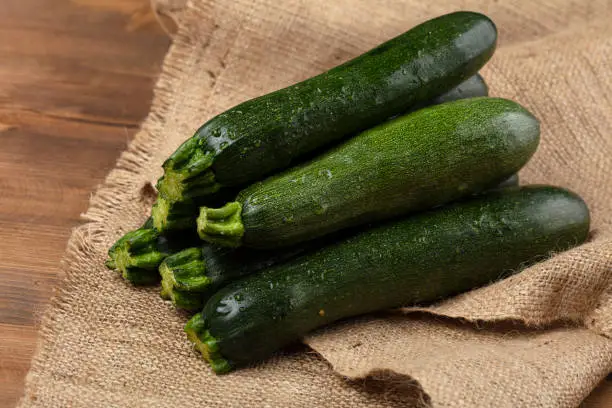 Photo of Organic fresh green zucchini, vegetable background.
