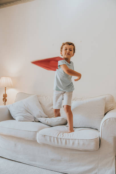 istock Boy playing with paper airplane 1266836153