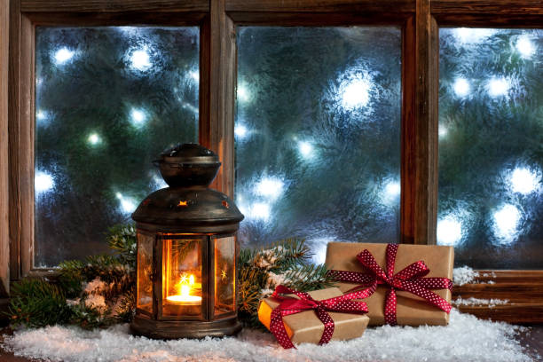 istock Christmas composition with holiday decoration on frost window 1266836334