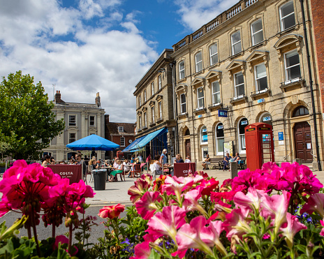 Dorset, UK - August 1st 2020: A summertime view The Square in the historic market town of Wimborne Minster in Dorset, UK.