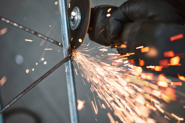 istock Man with a tool. Factory worker using electric grinder 1266838225
