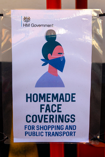 Dorset, UK - August 1st 2020: A public information sign outside a shop in the town of Shaftesbury in Dorset, UK - reminding people to wear face coverings for shopping and public transport.
