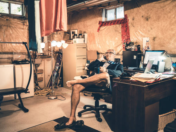 istock Mature man at work in his basement office 1266847073