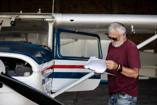 istock Senior man pilot checking ultralight airplane before flight 1266849220