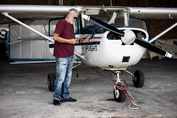 istock Senior man pilot checking ultralight airplane before flight 1266849257