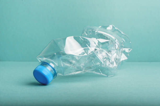 istock Used crushed plastic bottle on blue background. 1266849273