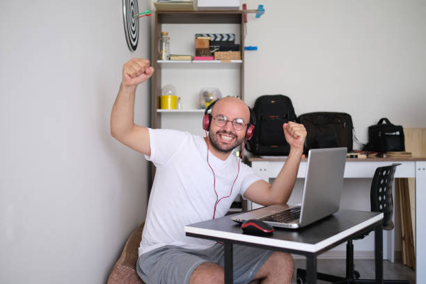 istock Young man who succeeded at the computer. rejoicing man celebrating his victory. 1266849873