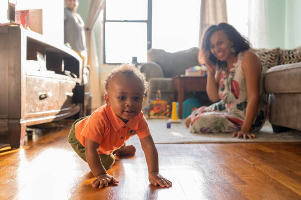 istock Mom playing with her kid while talks on the cell phone 1266851439