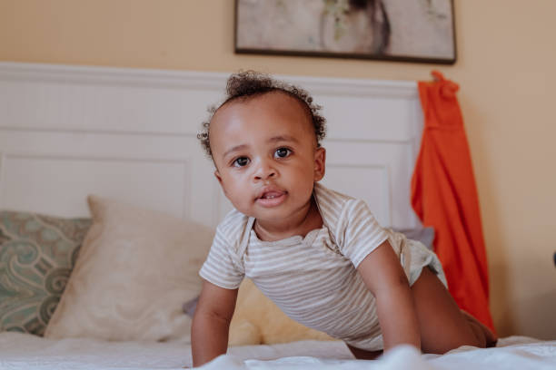 istock black kid on the bed looking at the camera 1266851457