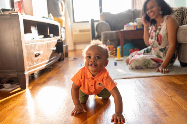 istock Mom playing with her kid while talks on the cell phone 1266851464
