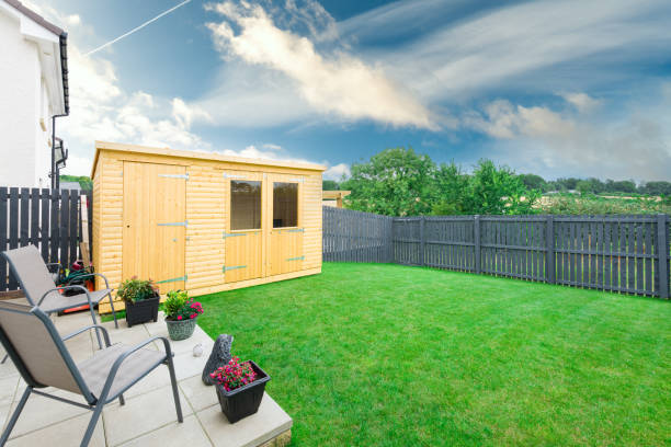 istock Modern Garden Designed and landscaped with newly Constructed Materials Including Silver Copse Painted Fencing , New Summer House and laid Turf lawn. 1266851539