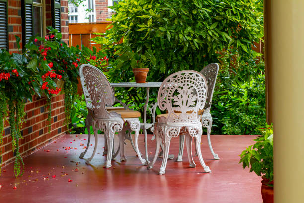 a decorative porch with metal lattice chairs and tables - ceramics column garden pot ceramic imagens e fotografias de stock