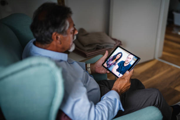 istock Caucasian senior man making a video call using digital tablet 1266857218