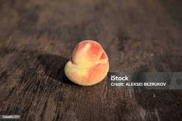 Ugly Ripe Fresh Peach On A Vintage Wooden Background Selective Focus Copy Space Concept Reducing Food Waste Stock Photo - Download Image Now