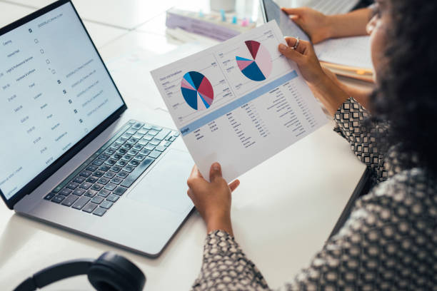istock Hands of an Anonymous Businesswoman Analyzing Financial Reports at Work 1266858218