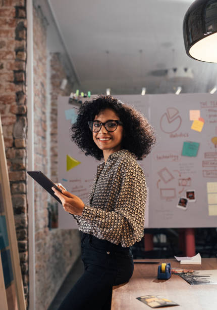 istock Portrait of a Smiling Young Designer Using a Digital Tablet at the Studio, Looking at Camera 1266858222