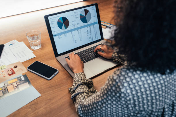 Anonymous Businesswoman Analyzing Statistical Business Reports on her Laptop PC at the Office, a Close Up
