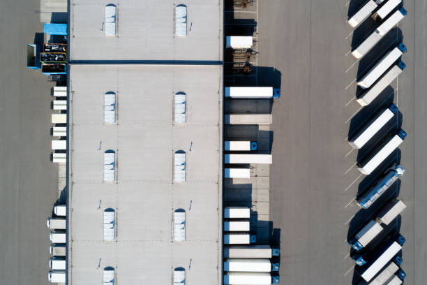 istock Distribution Warehouse and Trucks from Above 1266858790