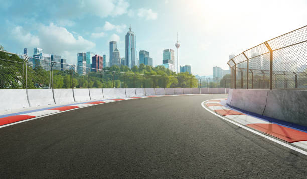 racetrack with railing and city background - car track imagens e fotografias de stock