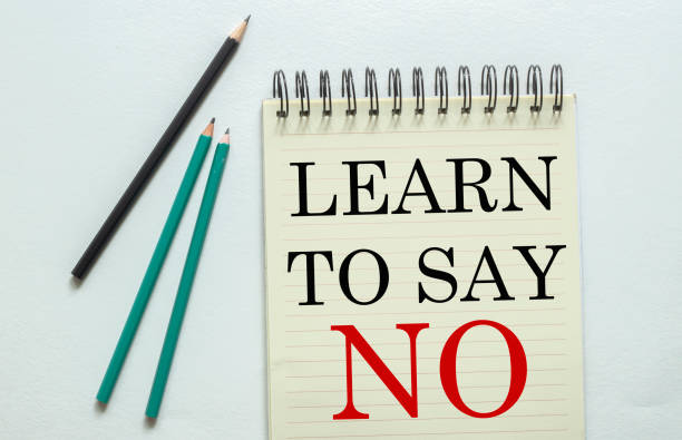 two green one black pencil with text Learn To Say No in the notebook on the white background two green one black pencil with text Learn To Say No in the notebook on the white background escribir stock pictures, royalty-free photos & images