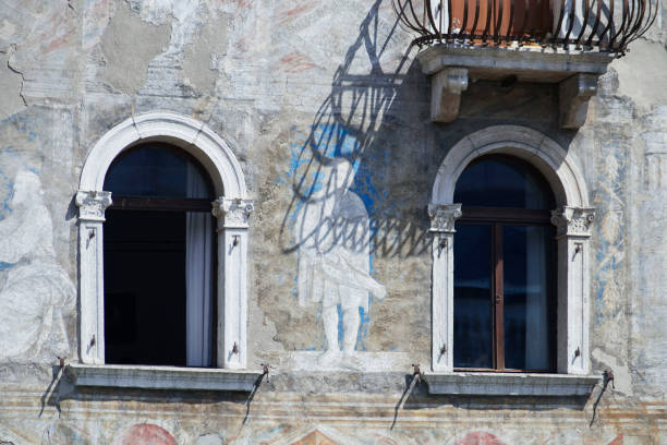 istock Two Italian windows on the antic painted wall facade 1266871528