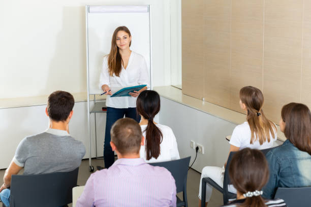 istock Woman presenting business project to partners 1266872609