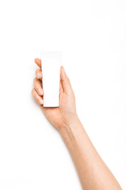 woman hand hold a cosmetic container sun cream on the white background.