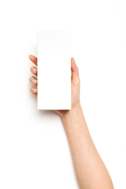 istock woman hand hold a cosmetic container big box on the white background. 1266873749