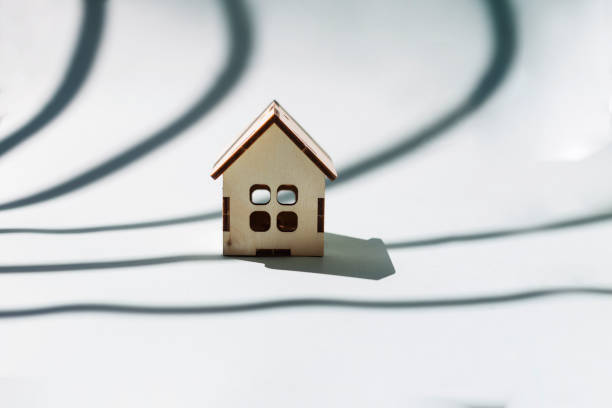 istock Small wooden house on a blue background. 1266876131