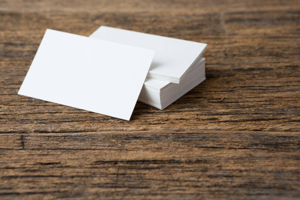 istock Stack of Business card on wood background and copy space 1266877473