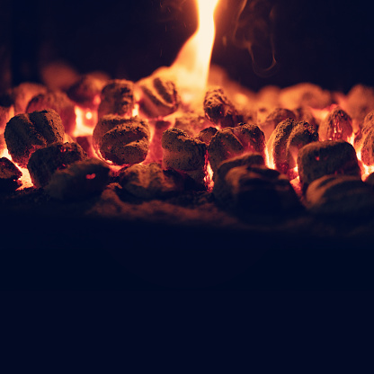 Macro close up of the glowing embers of a wood bonfire