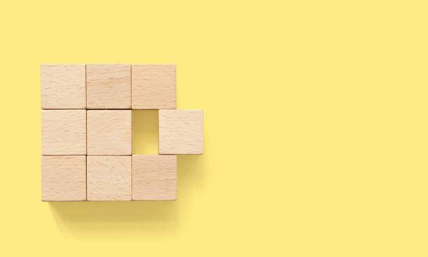 Group of wooden cube block on yellow background with copy space