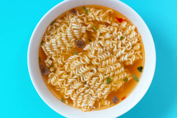 istock A bowl with ready instant noodles on blue background, top view 1266881039