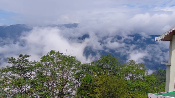 istock Scenic view of cloud touching the mountain peaks 1266886135