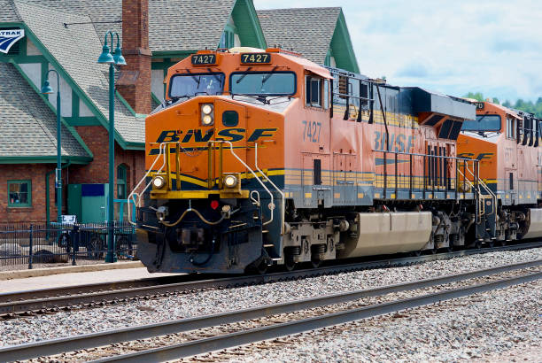 BNSF Locomotives #7427 and #6570 Pass the Flagstaff, Arizona, Amtrak Station Flagstaff, Arizona / USA - July 25, 2020: BNSF engines #7427 and #6570, GE Model ES44DC locomotives, lead a freight train as it passes the Flagstaff Amtrak Station and Visitors Center on a sunny summer afternoon in the heart of the historic district in this Northern Arizona city. 1926 stock pictures, royalty-free photos & images