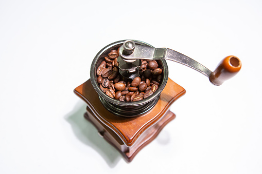 Roasted coffee beans and grinder